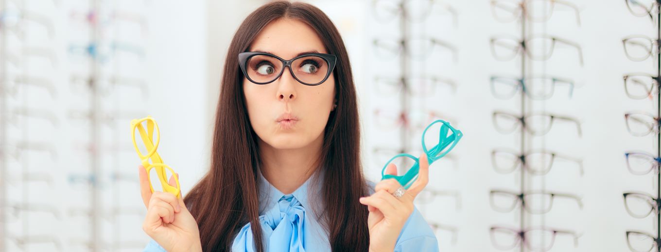 Choosing between two pairs of glasses at Perfect Focus Eyecare